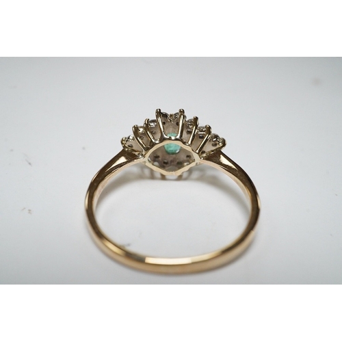 918 - A yellow metal, emerald and diamond cluster set navette shaped ring, size P, gross weight 2.3 grams.... 