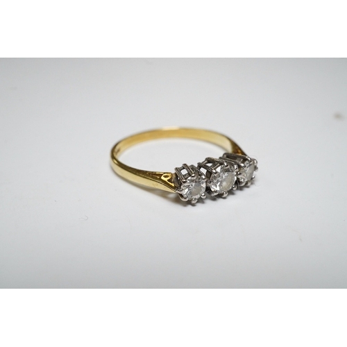 920 - A modern 18ct gold and three stone diamond set ring, size M, gross weight 2.1 grams. Condition - fai... 