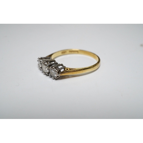 920 - A modern 18ct gold and three stone diamond set ring, size M, gross weight 2.1 grams. Condition - fai... 