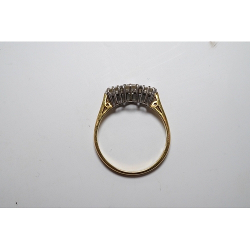 920 - A modern 18ct gold and three stone diamond set ring, size M, gross weight 2.1 grams. Condition - fai... 