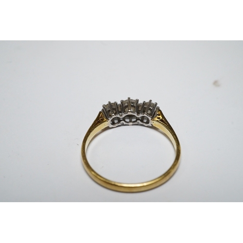 920 - A modern 18ct gold and three stone diamond set ring, size M, gross weight 2.1 grams. Condition - fai... 