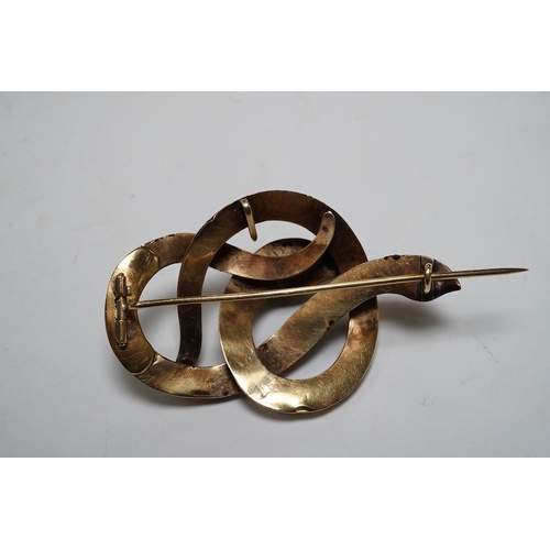 921 - A Victorian yellow metal and gem set coiled serpent brooch, 47mm, together with two 1960's 9ct gold ... 