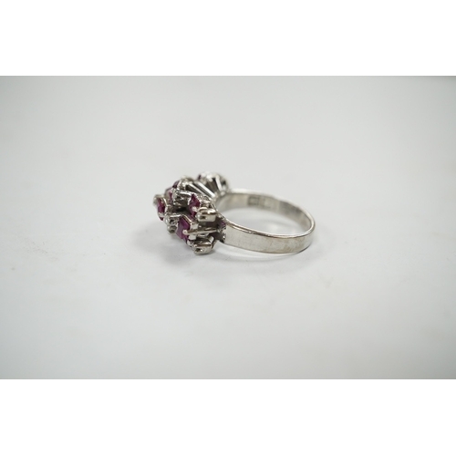 925 - An 18k white metal, ruby and diamond cluster set cocktail ring, size K/L, gross weight 5.7 grams. Co... 