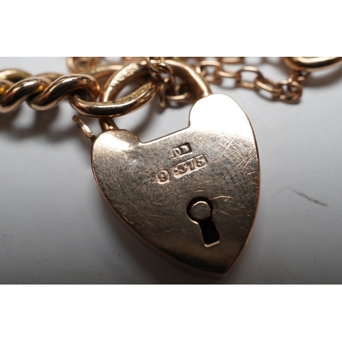 926 - A 9ct god curb link bracelet, with heart shaped padlock clasp, 18cm, 13.8 grams. Condition - fair to... 