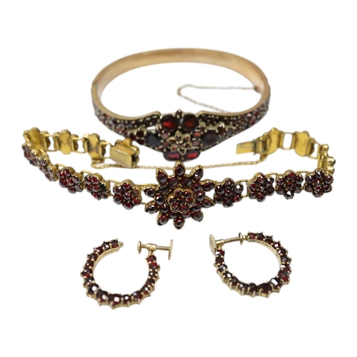 931 - Three items of gilt white metal and garnet paste cluster set jewellery, comprising a bracelet, bangl... 