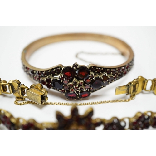 931 - Three items of gilt white metal and garnet paste cluster set jewellery, comprising a bracelet, bangl... 