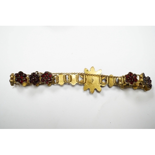 931 - Three items of gilt white metal and garnet paste cluster set jewellery, comprising a bracelet, bangl... 