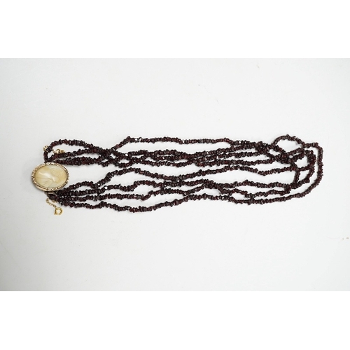 932 - A late 19th/early 20th century multi strand rough cut garnet set necklace, with a yellow metal mount... 