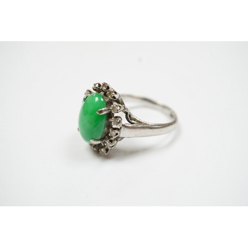 934 - A white metal, jade and diamond set oval cluster ring, size N, gross weight 5.4 grams. Condition - f... 