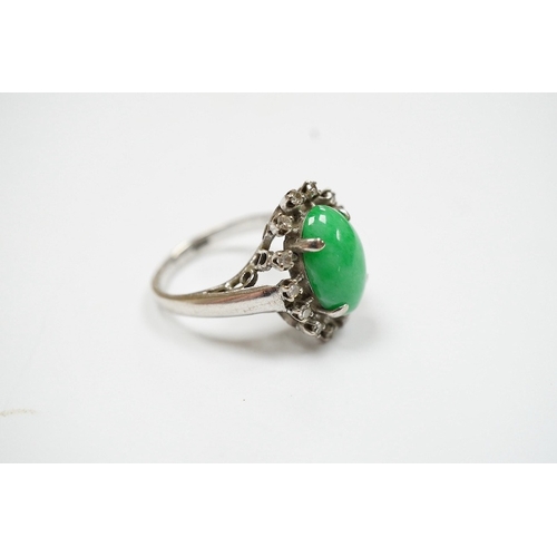 934 - A white metal, jade and diamond set oval cluster ring, size N, gross weight 5.4 grams. Condition - f... 