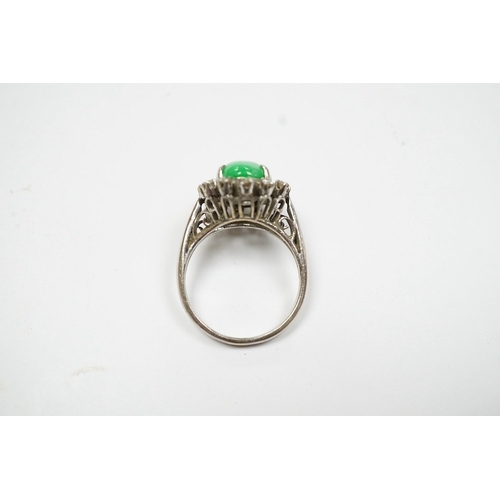 934 - A white metal, jade and diamond set oval cluster ring, size N, gross weight 5.4 grams. Condition - f... 