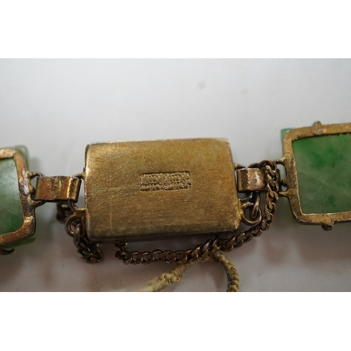 935 - A Chinese gilt white metal and carved jade panel set bracelet, a.f, 17.5cm, together with a carved j... 