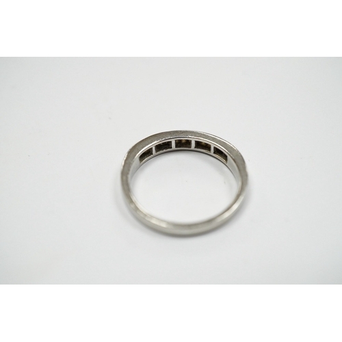 936 - A modern platinum and fifteen stone channel set baguette cut diamond set half hoop ring, size J, gro... 