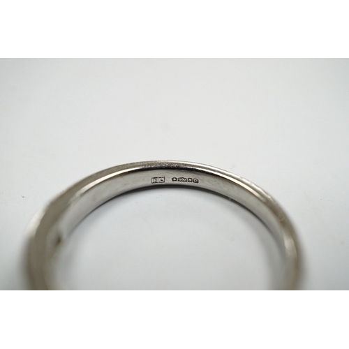 936 - A modern platinum and fifteen stone channel set baguette cut diamond set half hoop ring, size J, gro... 