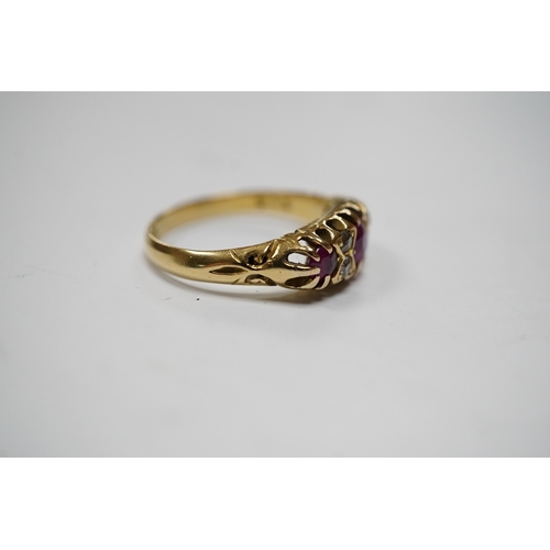 937 - A George V 18ct gold and three stone ruby set half hoop ring, with diamond chip spacers, (one stone ... 