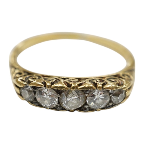 939 - A yellow metal and graduated five stone diamond set half hoop ring, size O, gross weight 3.1 grams. ... 