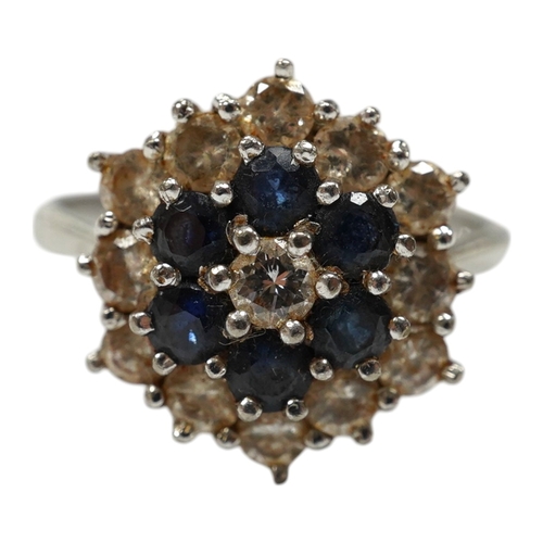 951 - An 18ct white metal, sapphire and diamond set cluster ring, size O, gross weight 4.1 grams. Conditio... 