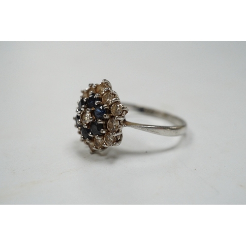 951 - An 18ct white metal, sapphire and diamond set cluster ring, size O, gross weight 4.1 grams. Conditio... 