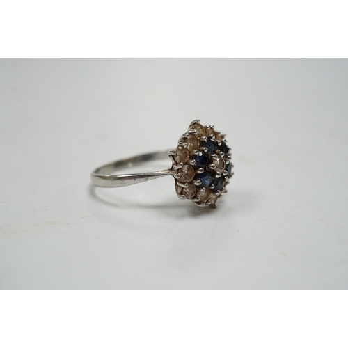 951 - An 18ct white metal, sapphire and diamond set cluster ring, size O, gross weight 4.1 grams. Conditio... 