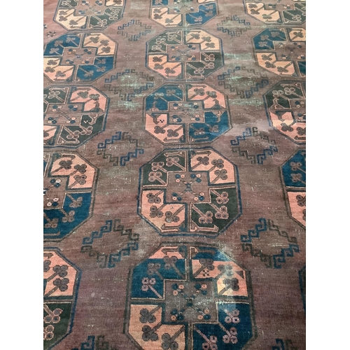 1005 - An Afghan red ground carpet, 380 x 240cm. Condition - poor to fair, one area of patching and several... 