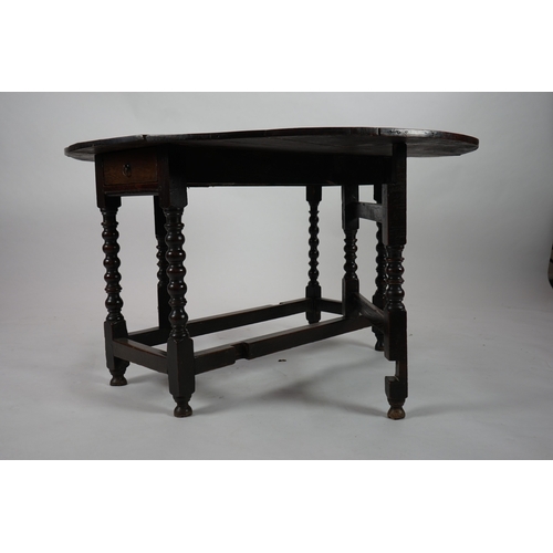 1039 - A 17th century and later oak gateleg table, with oval drop leaf top and single frieze drawer, on bob... 