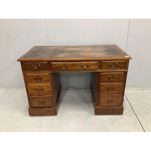 1050 - An early 20th century oak pedestal desk, fitted nine drawers, with a leather inset top, width 121cm,... 