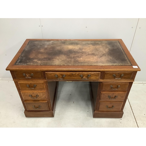 1050 - An early 20th century oak pedestal desk, fitted nine drawers, with a leather inset top, width 121cm,... 