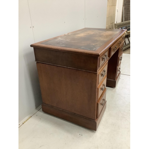 1050 - An early 20th century oak pedestal desk, fitted nine drawers, with a leather inset top, width 121cm,... 