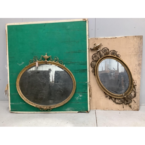 1067 - Two late Victorian / Edwardian Sheraton Revival oval giltwood and composition wall mirrors, larger w... 