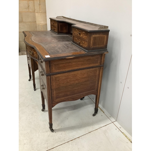 1068 - An Edwardian marquetry inlaid rosewood bowfront kneehole desk in the manner of Edwards and Roberts, ... 