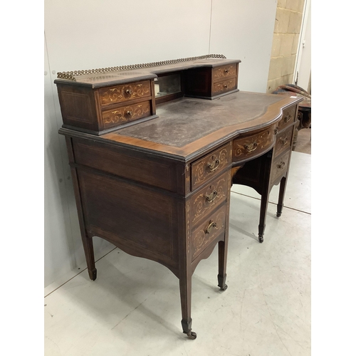 1068 - An Edwardian marquetry inlaid rosewood bowfront kneehole desk in the manner of Edwards and Roberts, ... 