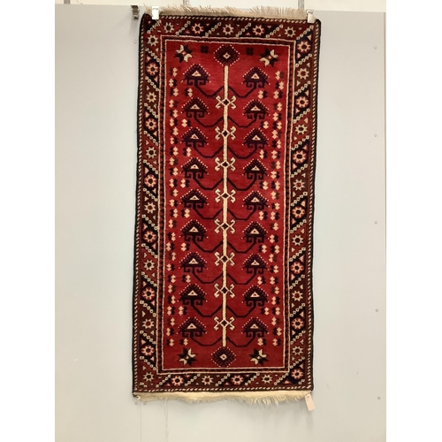 1089 - A Kazak style red ground rug, (moth damage) and a Turkish red ground rug, larger 200 x 98cm. Conditi... 