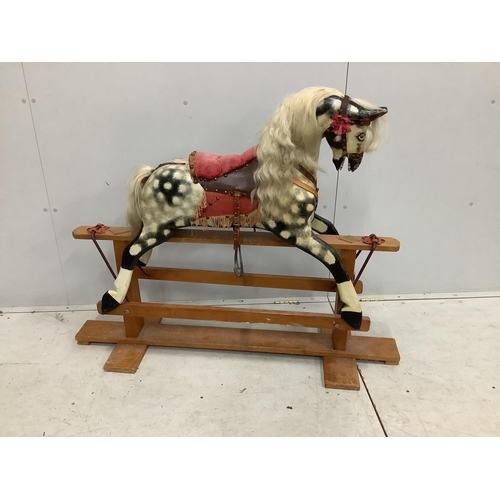 1101 - A dapple grey rocking horse, on beech safety frame, length 127cm, height 100cm. Condition - fair... 