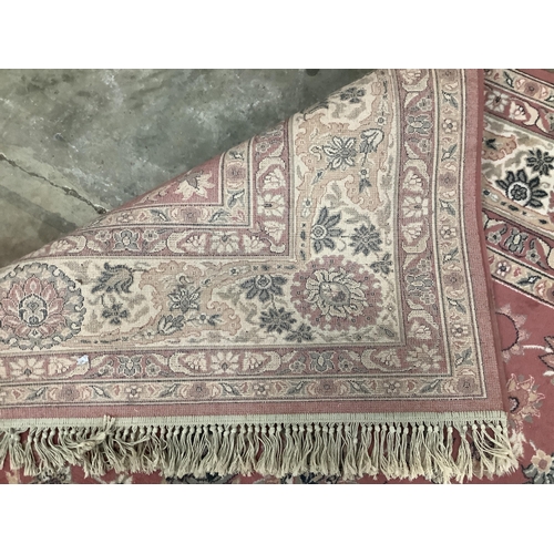 1104 - A Kashan style peach ground machined carpet, 360 x 274cm. Condition - fair to good, will require cle... 