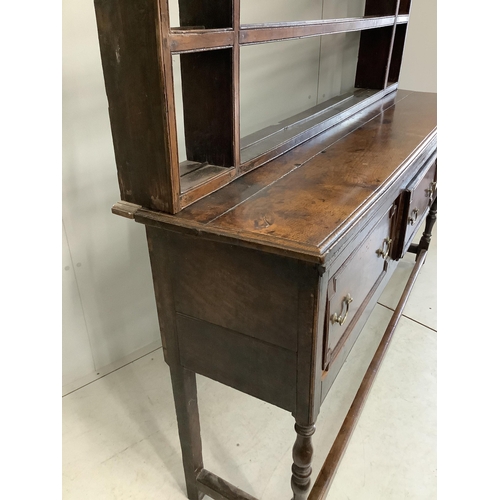 1121 - An 18th century oak dresser with open rack, width 176cm, depth 46cm, height 199cm. Condition - fair... 