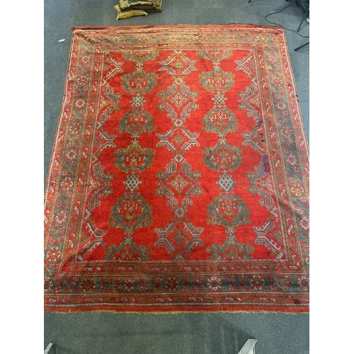 1158 - A large Turkish carpet, with triple row of stylised medallions on a red ground, multi bordered, 413 ... 