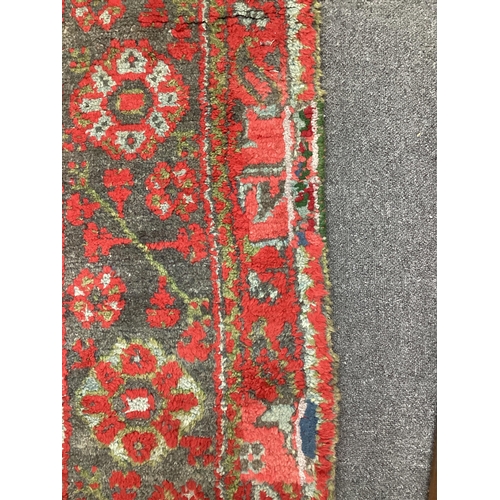 1158 - A large Turkish carpet, with triple row of stylised medallions on a red ground, multi bordered, 413 ... 