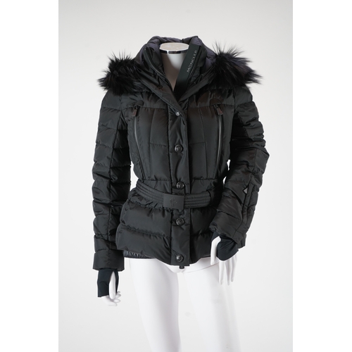 1242 - A lady's Moncler Grenoble down black ski jacket with fur trimmed hood and belted waist. UK size 10... 