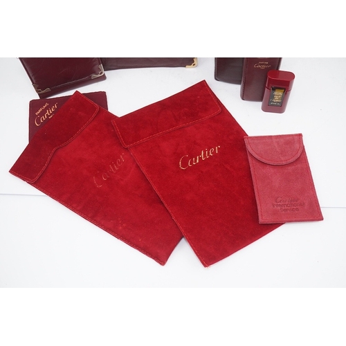 1252 - An assortment of Must de Cartier bordeaux leather accessories including small coin purse, two wallet... 