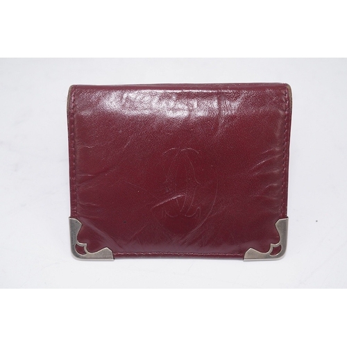 1252 - An assortment of Must de Cartier bordeaux leather accessories including small coin purse, two wallet... 