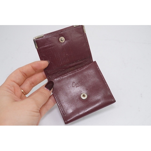 1252 - An assortment of Must de Cartier bordeaux leather accessories including small coin purse, two wallet... 