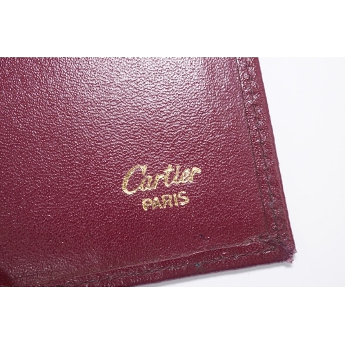 1252 - An assortment of Must de Cartier bordeaux leather accessories including small coin purse, two wallet... 