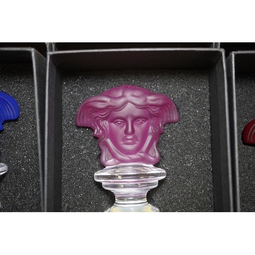 1289 - Seven boxed Rosenthal for Versace glass Medusa head wine bottle stoppers in various colours. Conditi... 