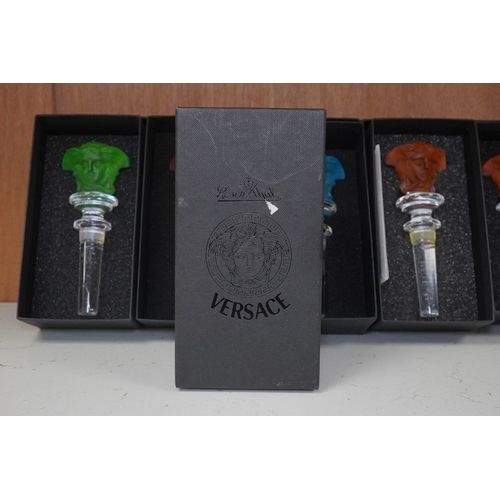 1291 - Six boxed Rosenthal for Versace glass Medusa head wine bottle stoppers in various colours and a boxe... 