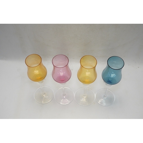 1300 - Four boxed Rosenthal for Versace Medusa head grappa glasses in various colours, 21.5cm high. Conditi... 