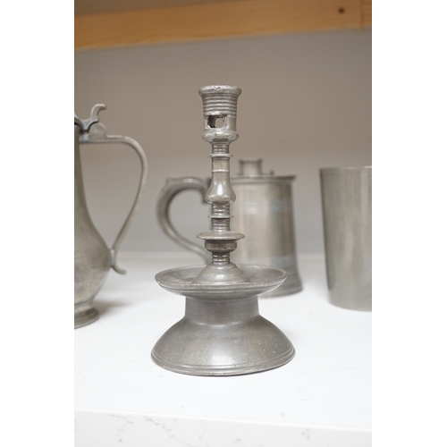 1331 - Six items of 18th century and later pewter including a jug, candlesticks, a pint measure, and a bron... 