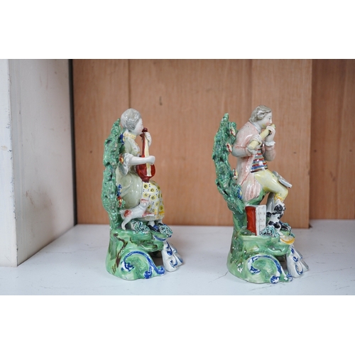 1341 - A pair of early 19th century pearlware groups of seated musicians with dogs, 15.5 cm high, Condition... 