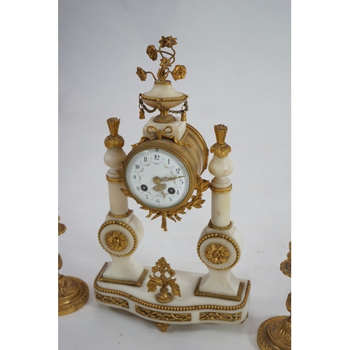 1358 - An early 20th century French ormolu mounted white mounted portico clock with flowering urn surmount ... 