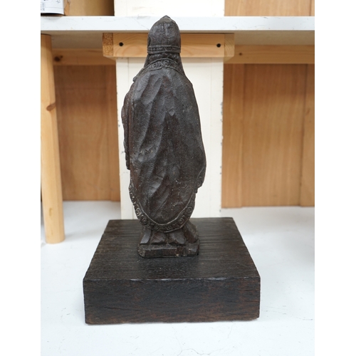 1372 - A North European oak carving of a bishop, possibly 17th/18th century, 38cm high not including stand.... 