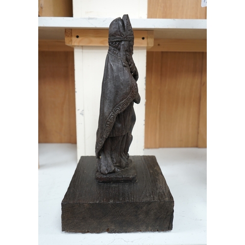 1372 - A North European oak carving of a bishop, possibly 17th/18th century, 38cm high not including stand.... 